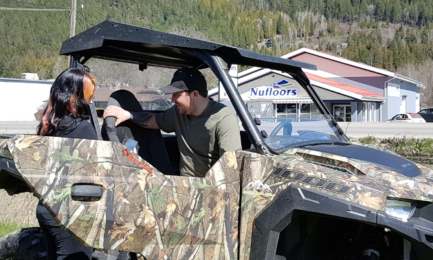 Jessica Vance helps a customer with his Polaris RZR. 