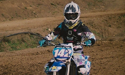 A young lady riding a dirt bike