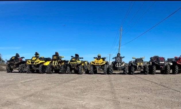 Group of Mayhem Mudders riders lined up on machines