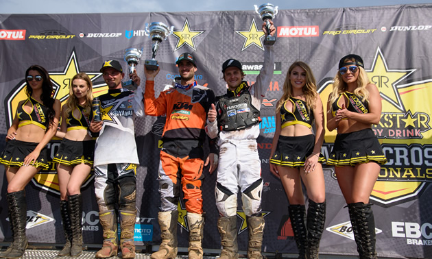 Tyler Medaglia holding his trophy on the podium at Round 7 in Pleasant Valley Raceway. 