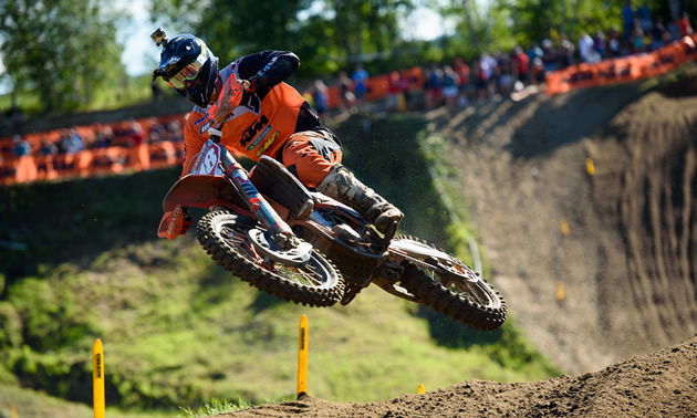 Davi Millsaps whipping his bike over a jump on the motocross track. 