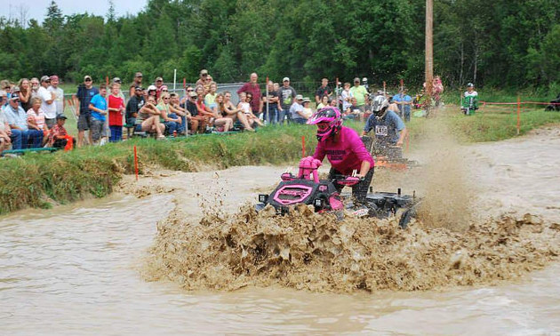 Anne Kotula of Grand Rapis Minnesota riding her ATV through a mud bog. 