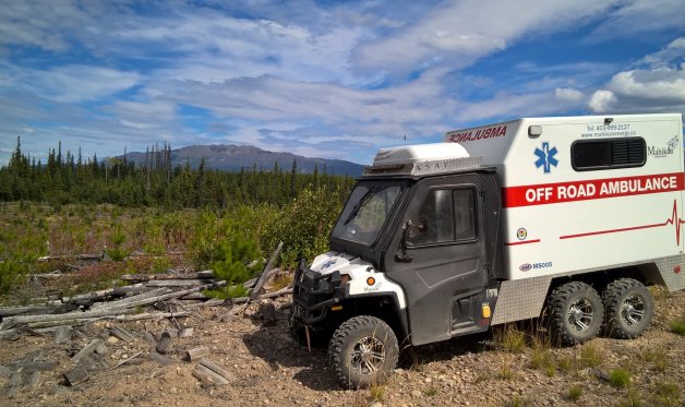 Providing medical services on a remote worksite with a custom off-road ambulance.