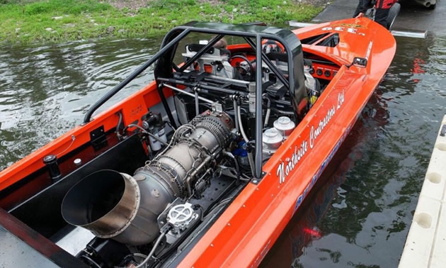 Shown is a General Electric turbine engine in the rear of a red jet boat. The engine is 1600 horsepower.