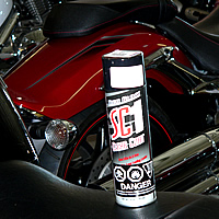 A can of detailing spray sitting on the seat of a motorcycle. 