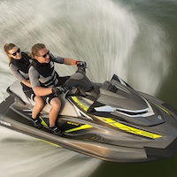 A man and a women on a personal water craft.