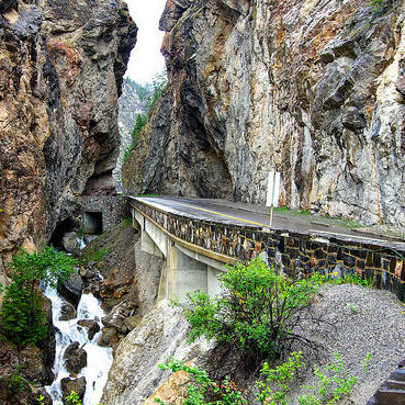 A curved road going through a rock-cut near Radium Hot Springs, B.C.