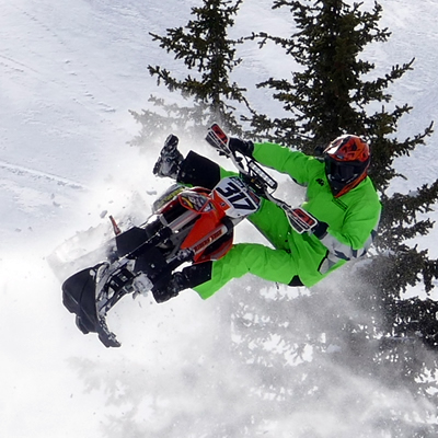 Reagan Sieg taking a huge jump in the mountains with his Timbersled snow bike. 
