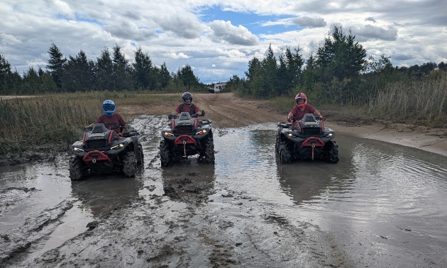 ATVers riding through mud