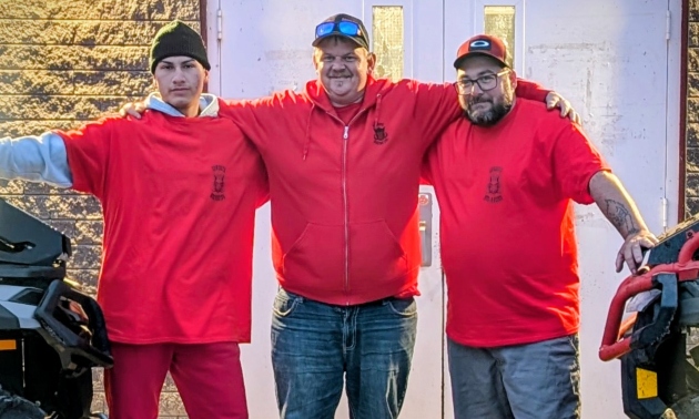 Ryan and two other Cowboys members wearing red shirts