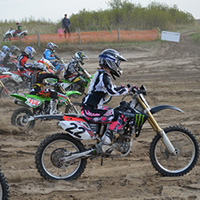 Dirt bike racers coming off the start line. 