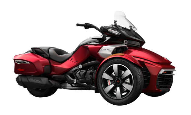 A red Spyder F3 bagger with windshield and built-in saddlebags. 