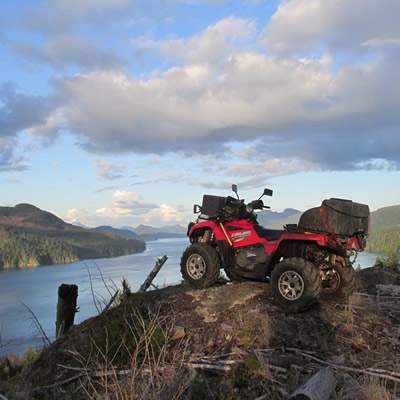 An ATV sitting on top of a mountain overlooking the Johnstone Strait. 