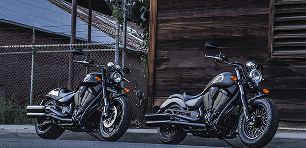 Two black and grey Victory motorcycles. 