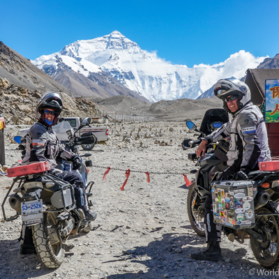 Sara and Daniel Pedersen on their motorcycles, looking at Mount Everest. 