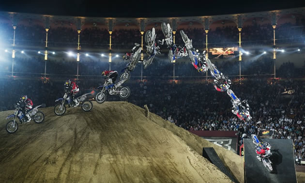 A freestyle motocross rider doing a trick at Red Bull X-Fighters. 